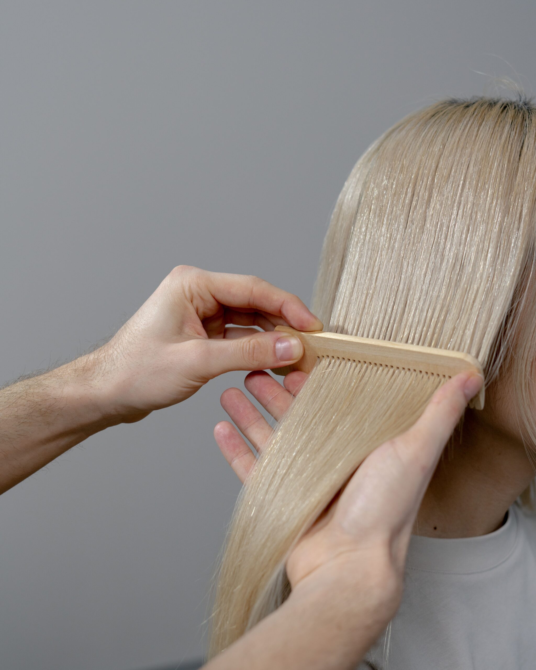 Coiffeuse peignant les cheveux d'une cliente